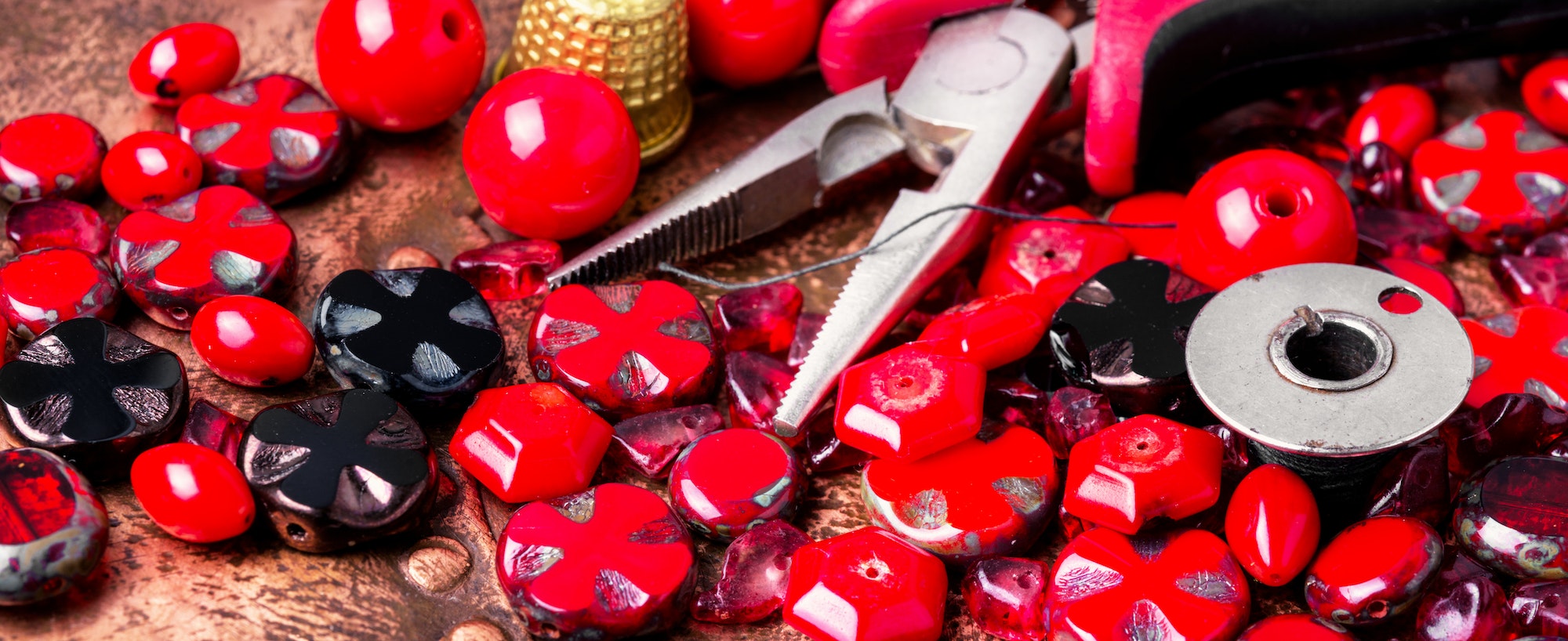 Making necklaces of glass beads.