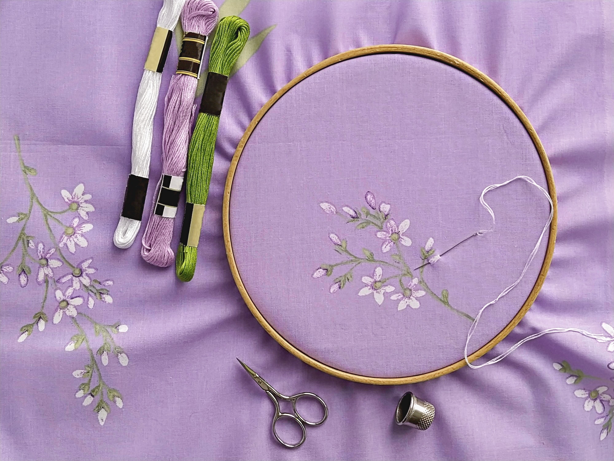 Vintage wooden embroidery hoops, scissors, needle, thread and fabric with pattern for embroidery